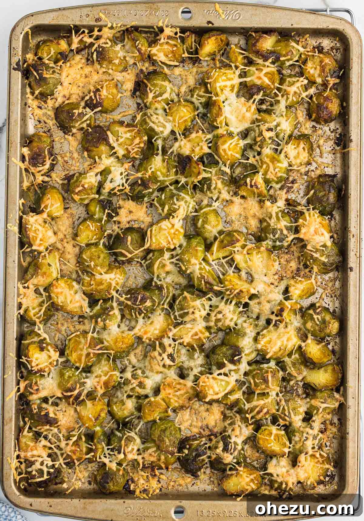 Finished roasted frozen Brussels sprouts with Parmesan cheese, golden brown and crispy, straight out of the oven.