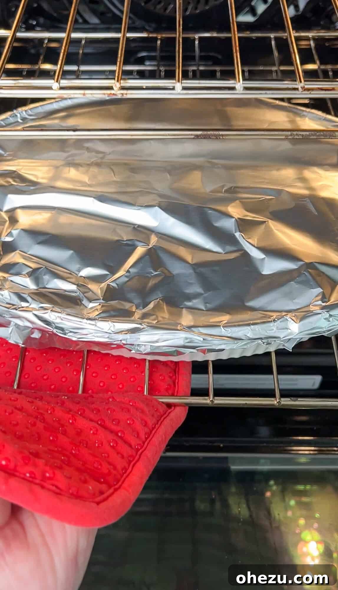 Zesty Greek Chicken Casserole 13 Casserole dish covered tightly with aluminum foil, placed into a hot oven for baking.