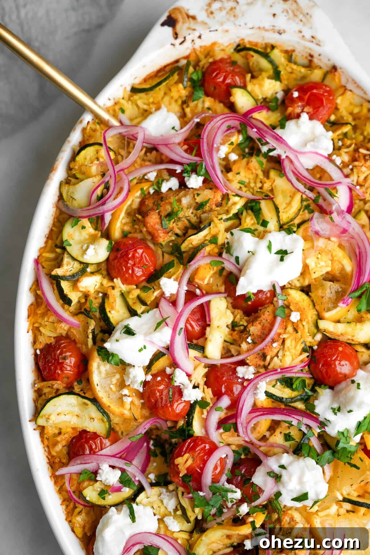 Zesty Greek Chicken Casserole 14 Finished Chicken Tzatziki Casserole, topped with fresh feta, pickled red onions, parsley, and a drizzle of tzatziki sauce.