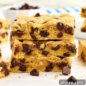 Stacked cake mix cookie bars with a bite taken out, showing the soft interior