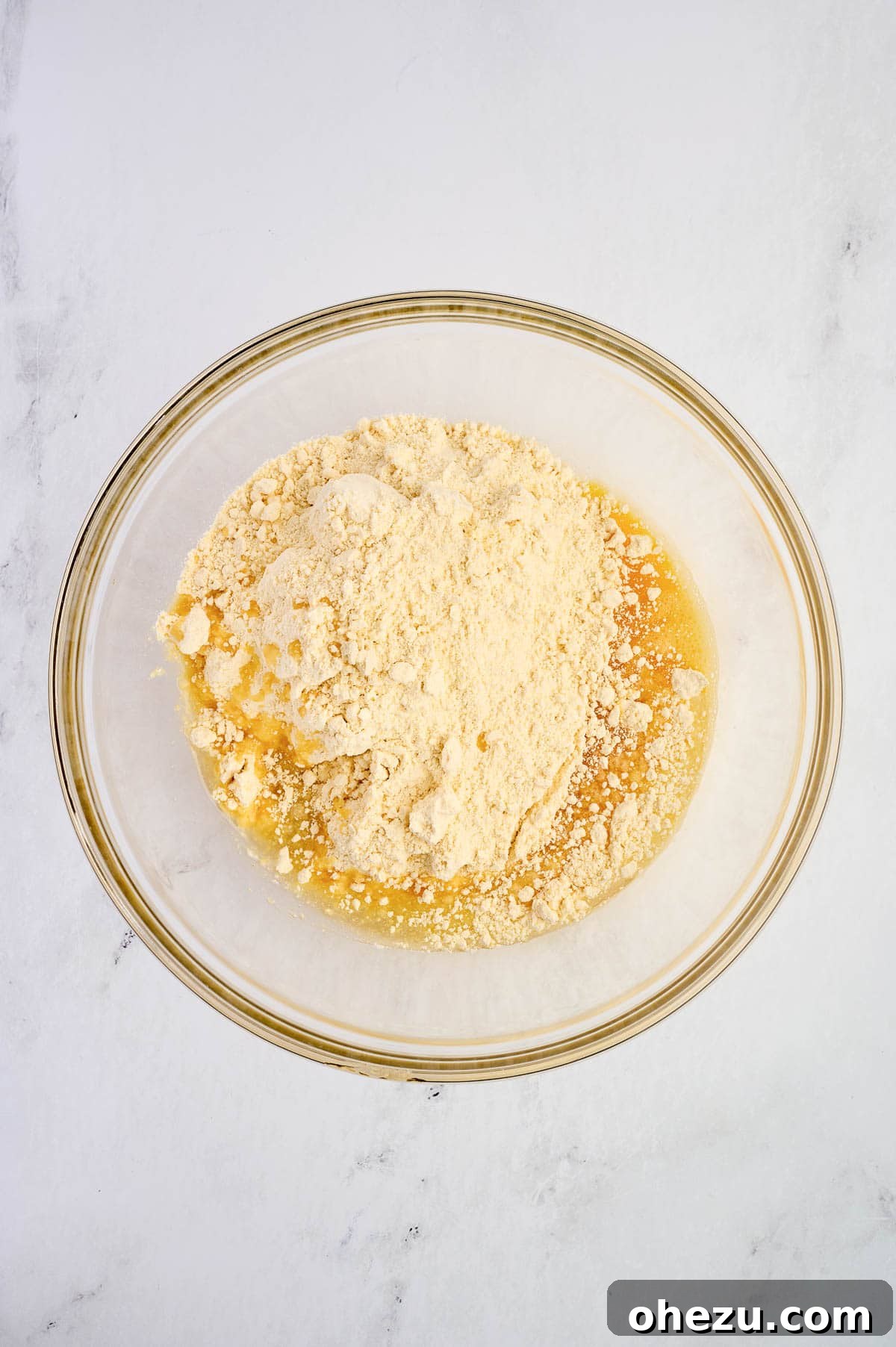 Cake mix, oil, and beaten eggs in a mixing bowl, beginning to combine