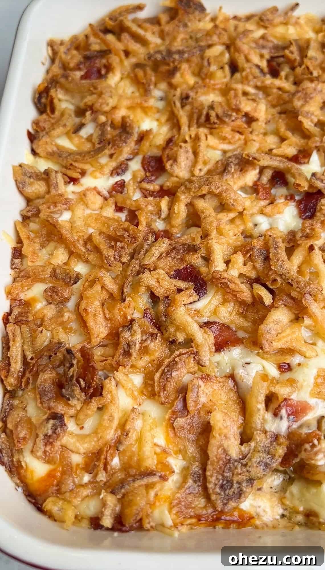 Baked caramelized onion dip fresh out of the oven, golden and bubbly