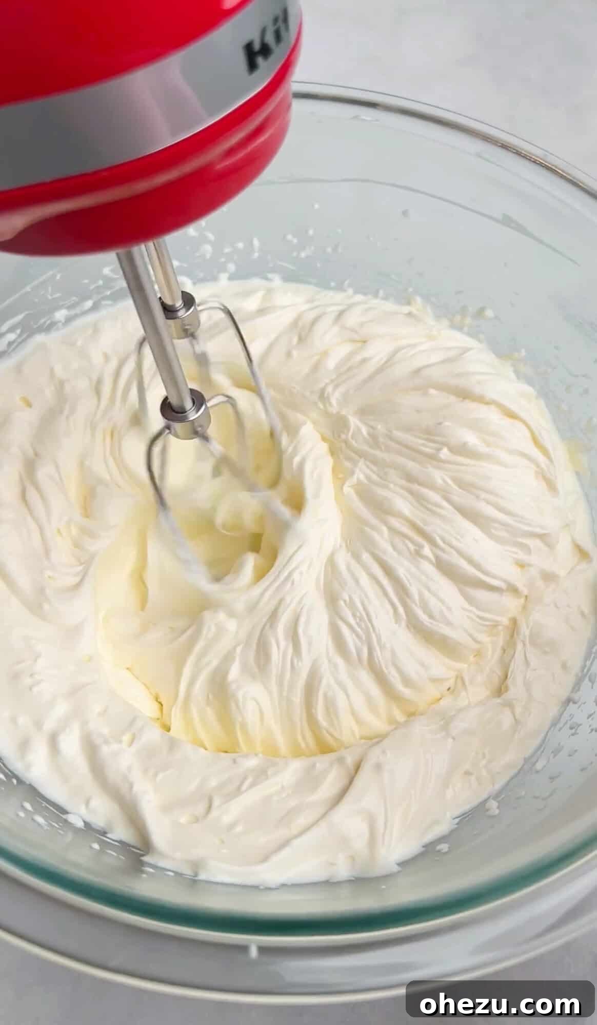 Mixing together the creamy base for the dip with a hand mixer