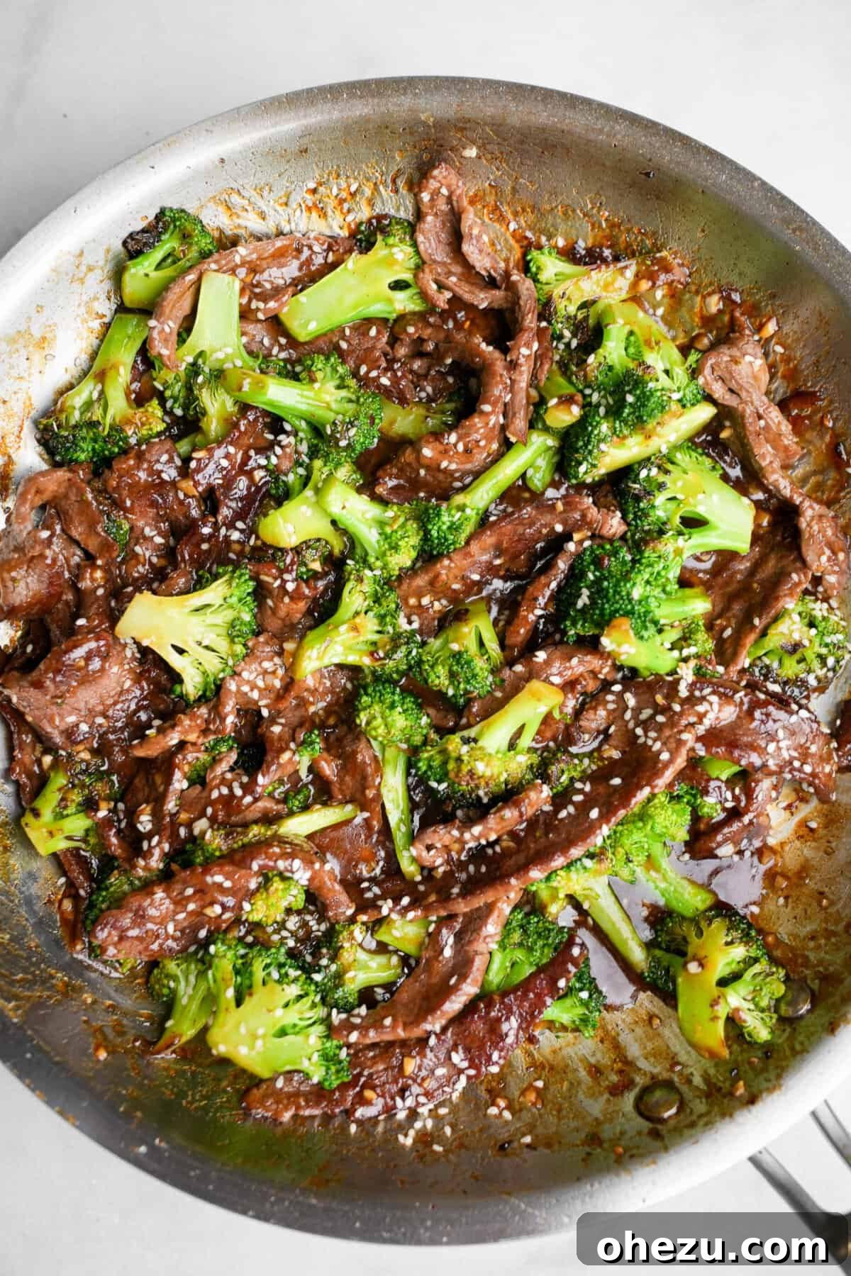 Sizzling beef and broccoli stir-fry in a large pan, ready to serve