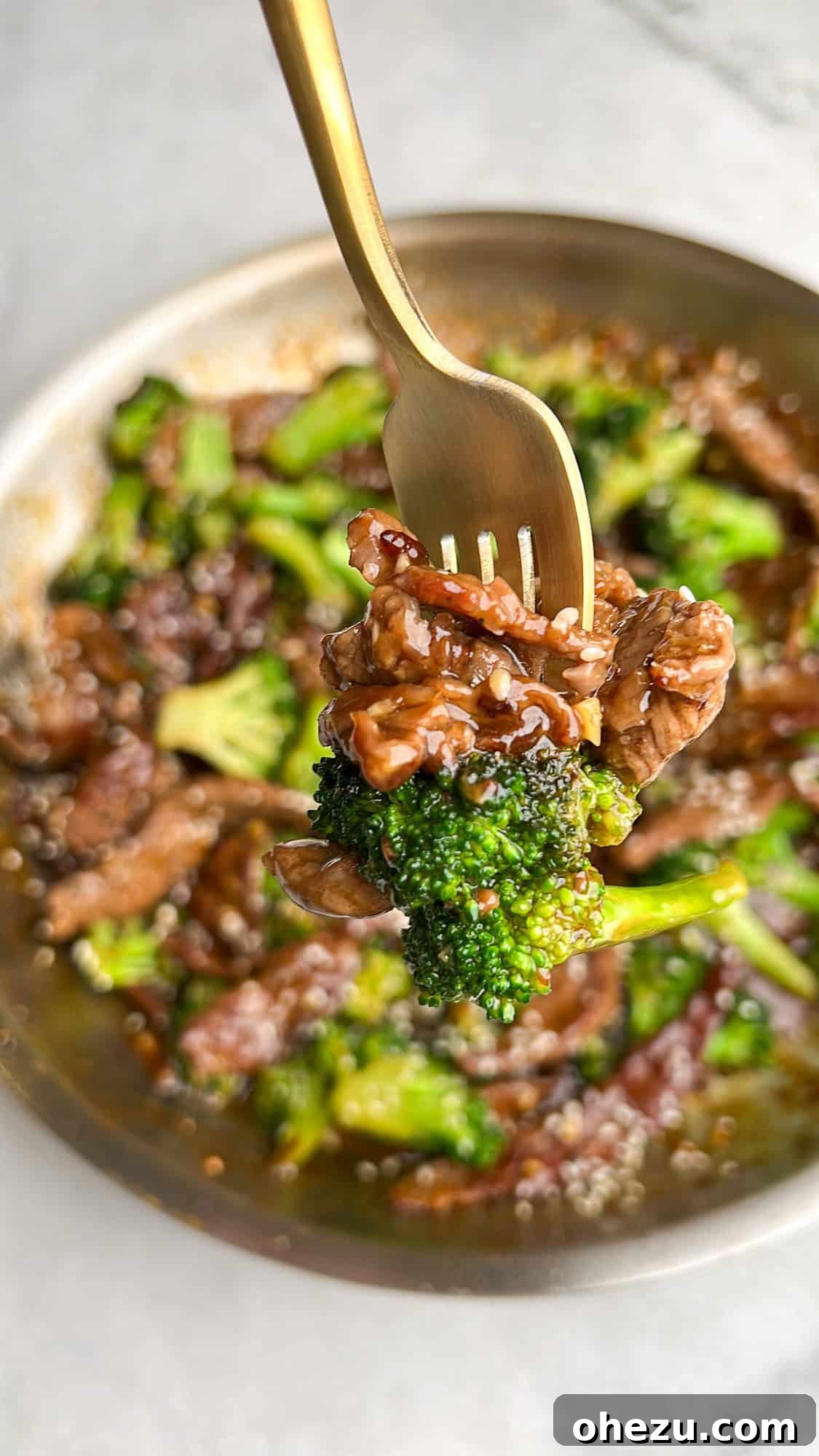 A fork lifting a piece of tender beef and broccoli, showing the perfect texture