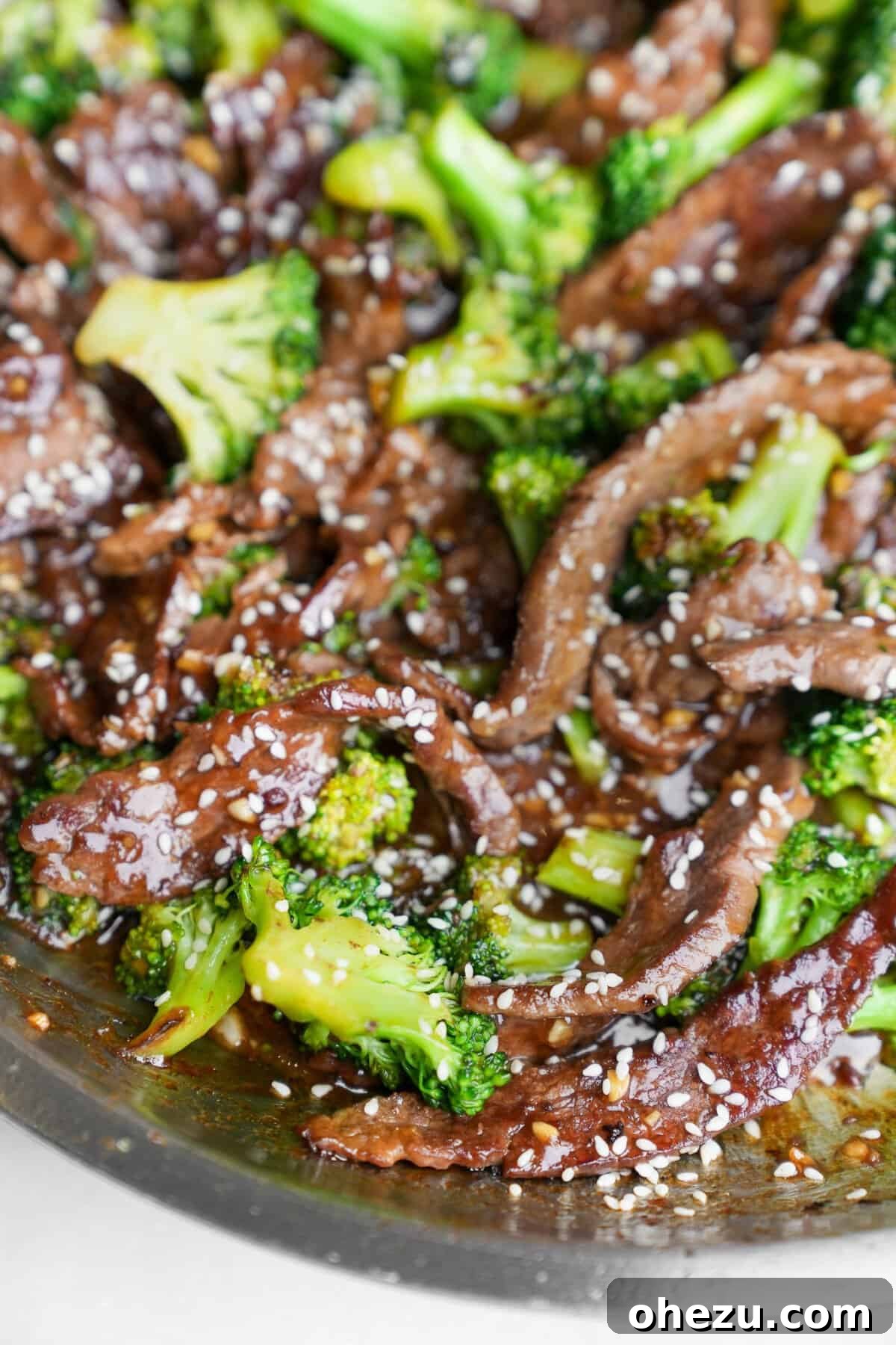 A close-up of a generous portion of beef and broccoli stir-fry in a pan