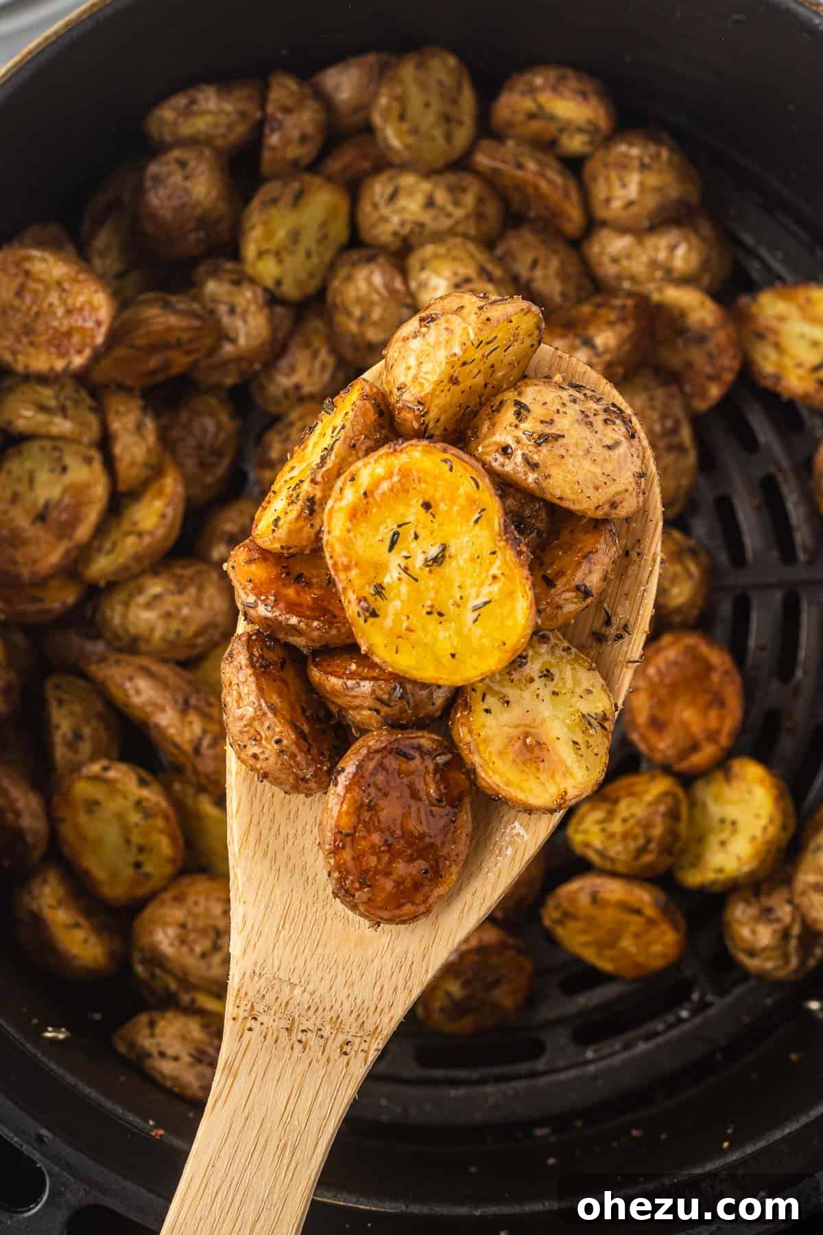 Crispy Air Fryer Baby Potatoes 14 air fryer potatoes on a wooden spoon