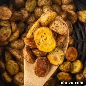 Crispy Air Fryer Baby Potatoes 16 air fryer potatoes on a wooden spoon