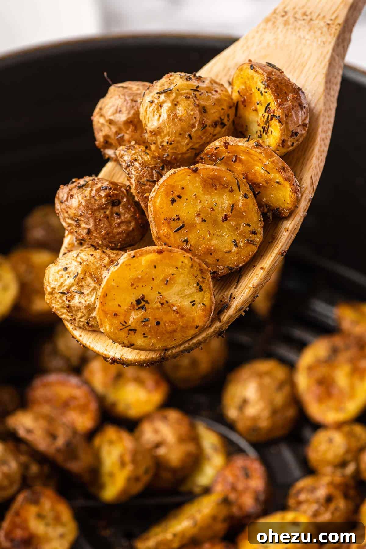 Crispy Air Fryer Baby Potatoes 3 air fryer potatoes on a wooden spoon