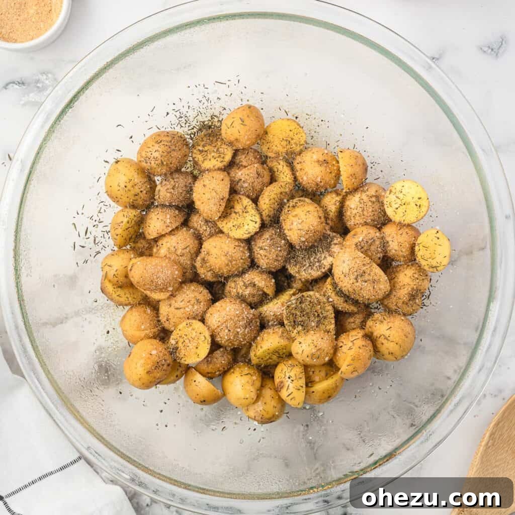 Crispy Air Fryer Baby Potatoes 7 adding spices to the potatoes