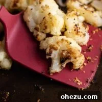 A red spatula with roasted frozen cauliflower on it