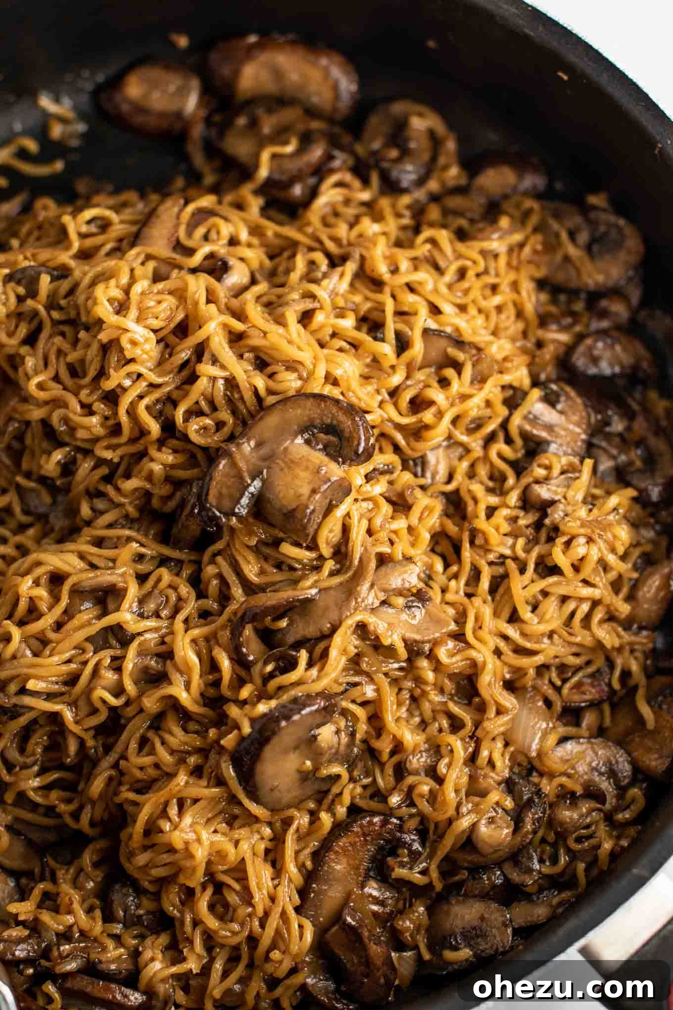 easy ramen stir fry with mushrooms from an overhead view in the pan, showcasing the vibrant ingredients