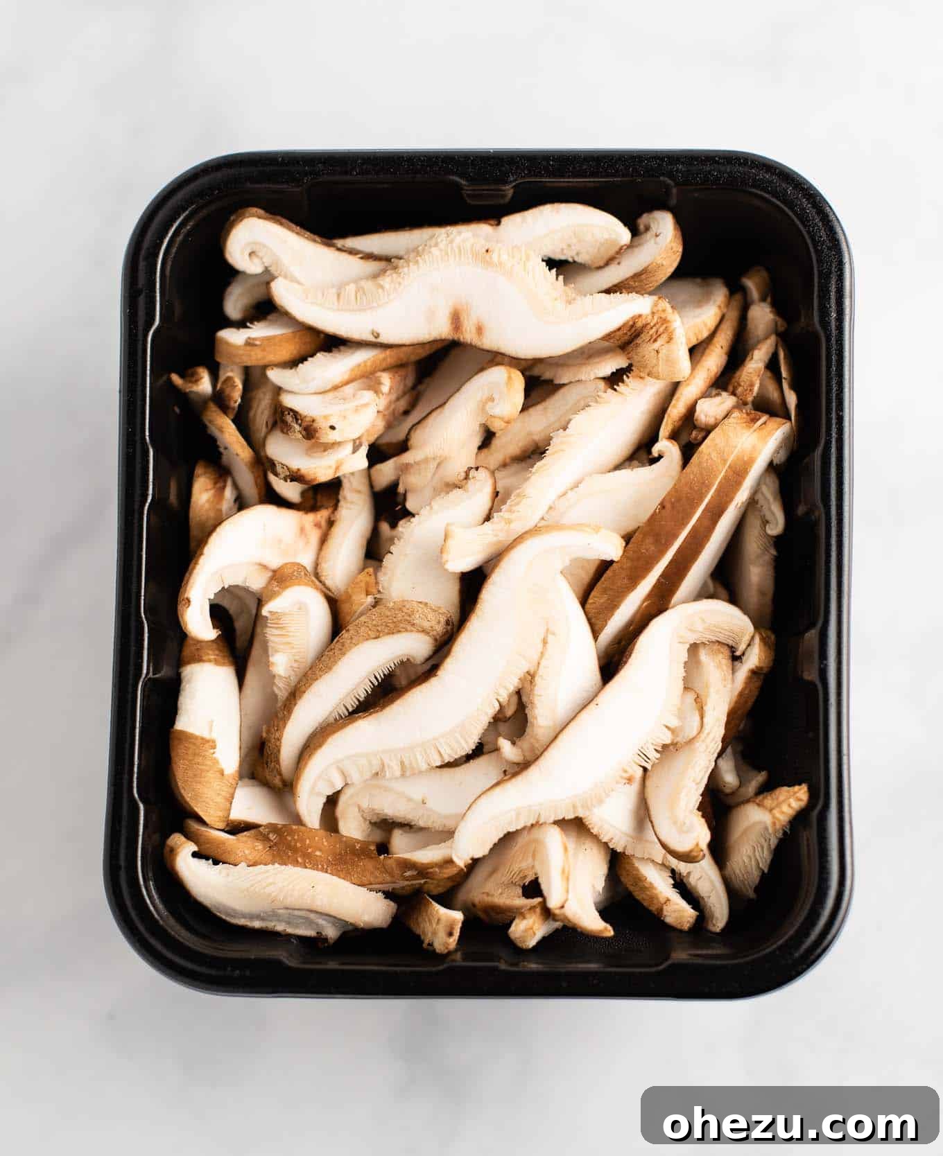 golden oak shiitake sliced mushrooms in a produce container, ready for use
