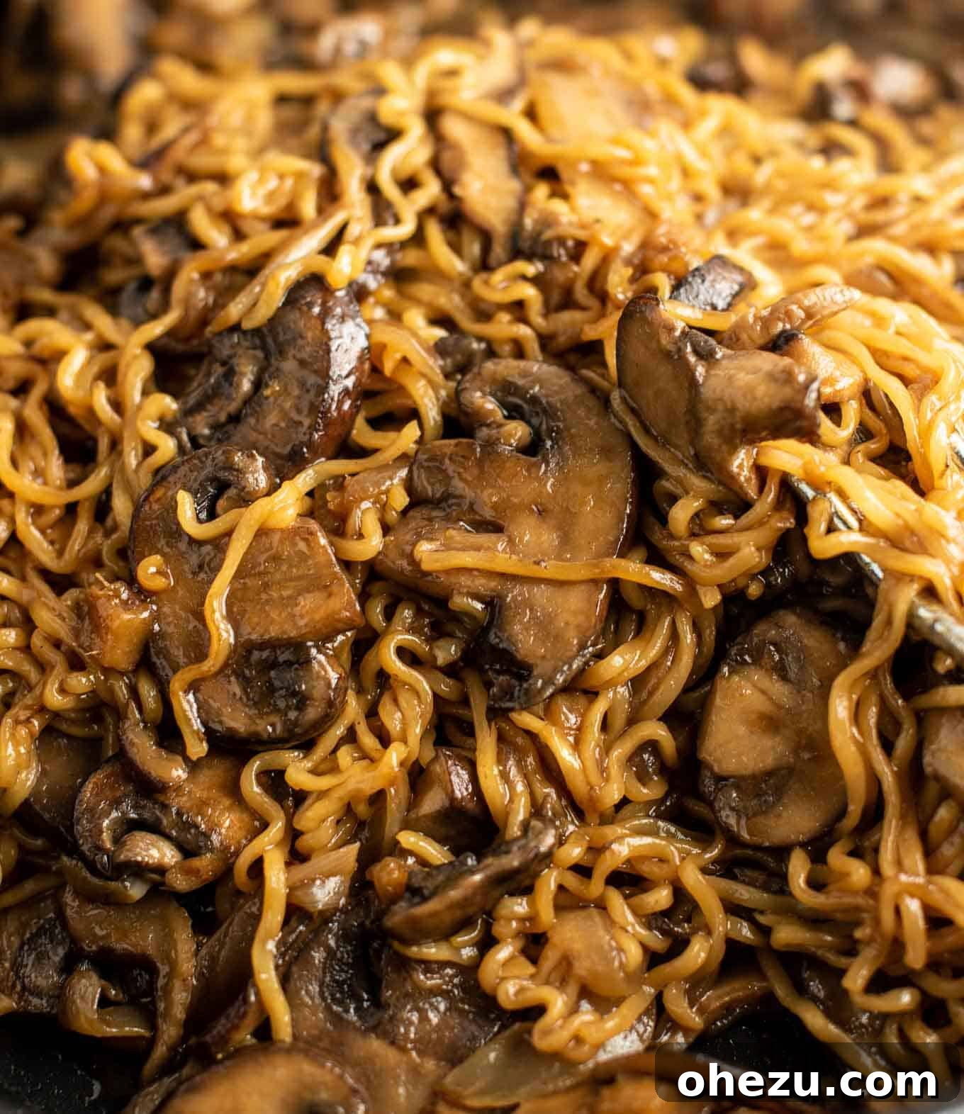 asian noodles close up shot, showcasing the texture and sauce coating