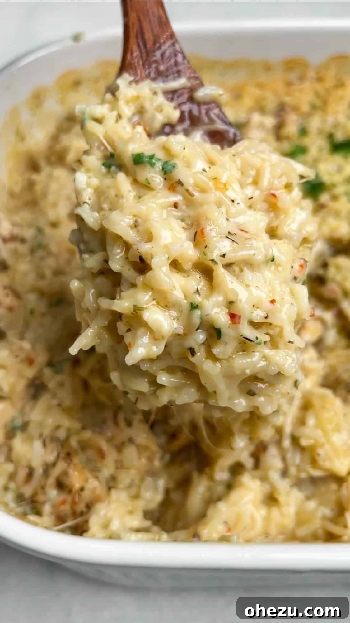 Golden Garlic Parmesan Chicken Rice Bake 8 chicken rice casserole on a serving spoon