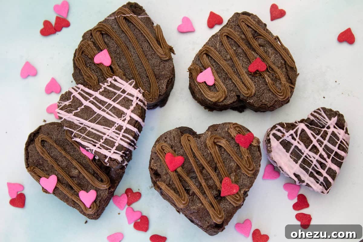 Finished Cherry Chocolate Valentine Heart Brownies, artfully decorated with piped frosting and sprinkles.