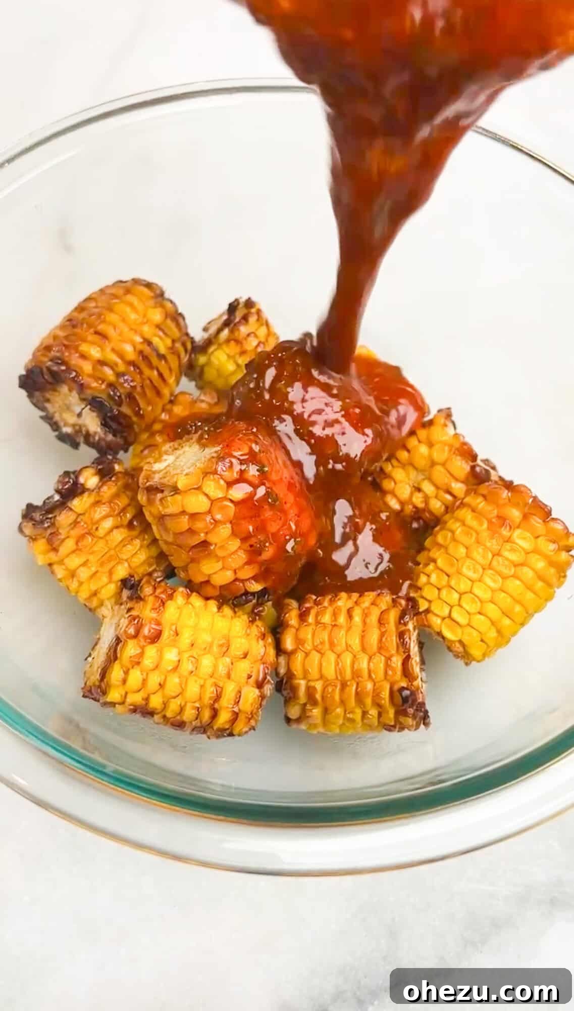 melted butter pouring over corn