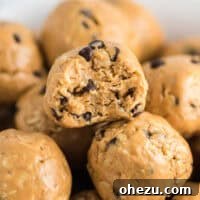 Close-up of a peanut butter energy ball with a bite taken out, showing its texture.