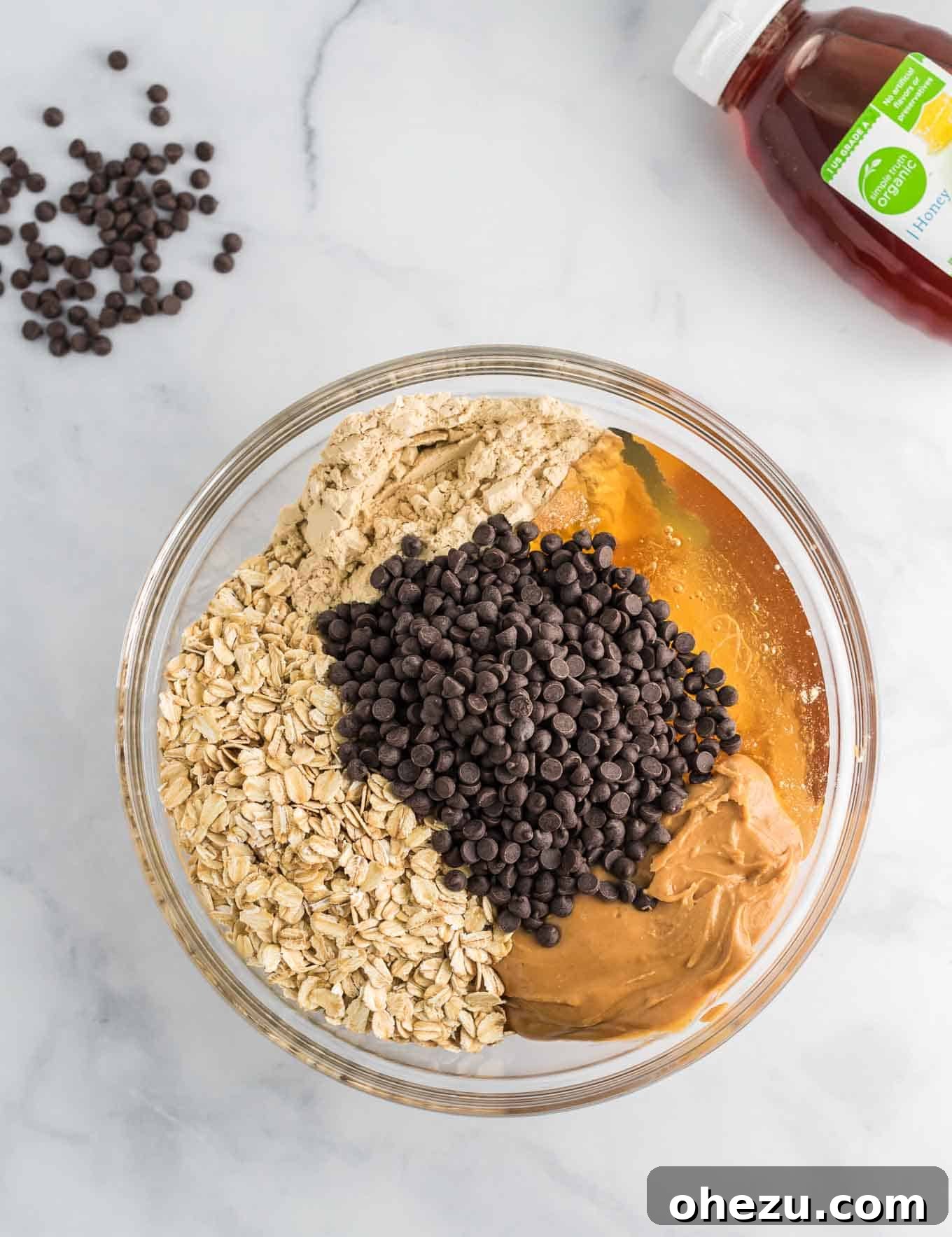All the energy ball ingredients are added together in a large mixing bowl, ready to be combined.