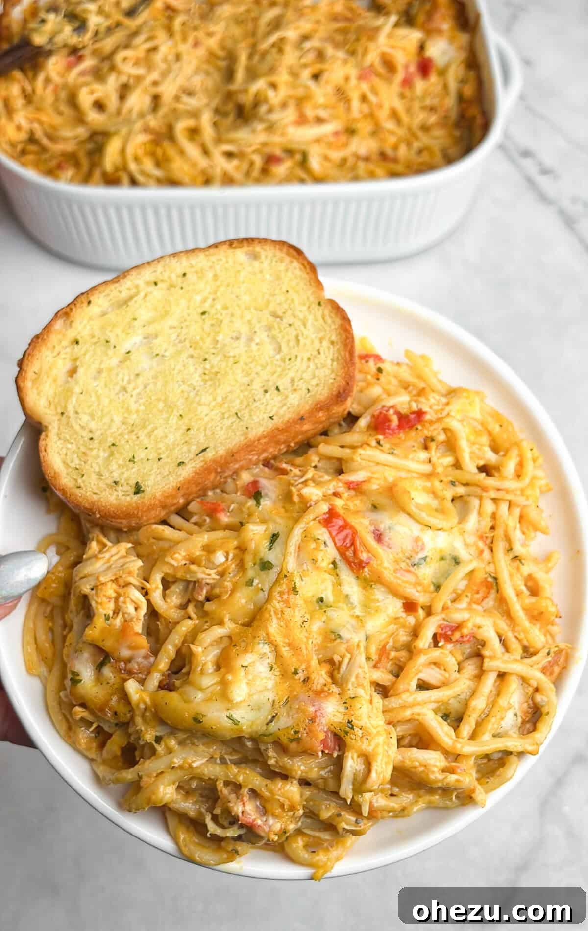 chicken spaghetti with rotel on a plate with texas toast