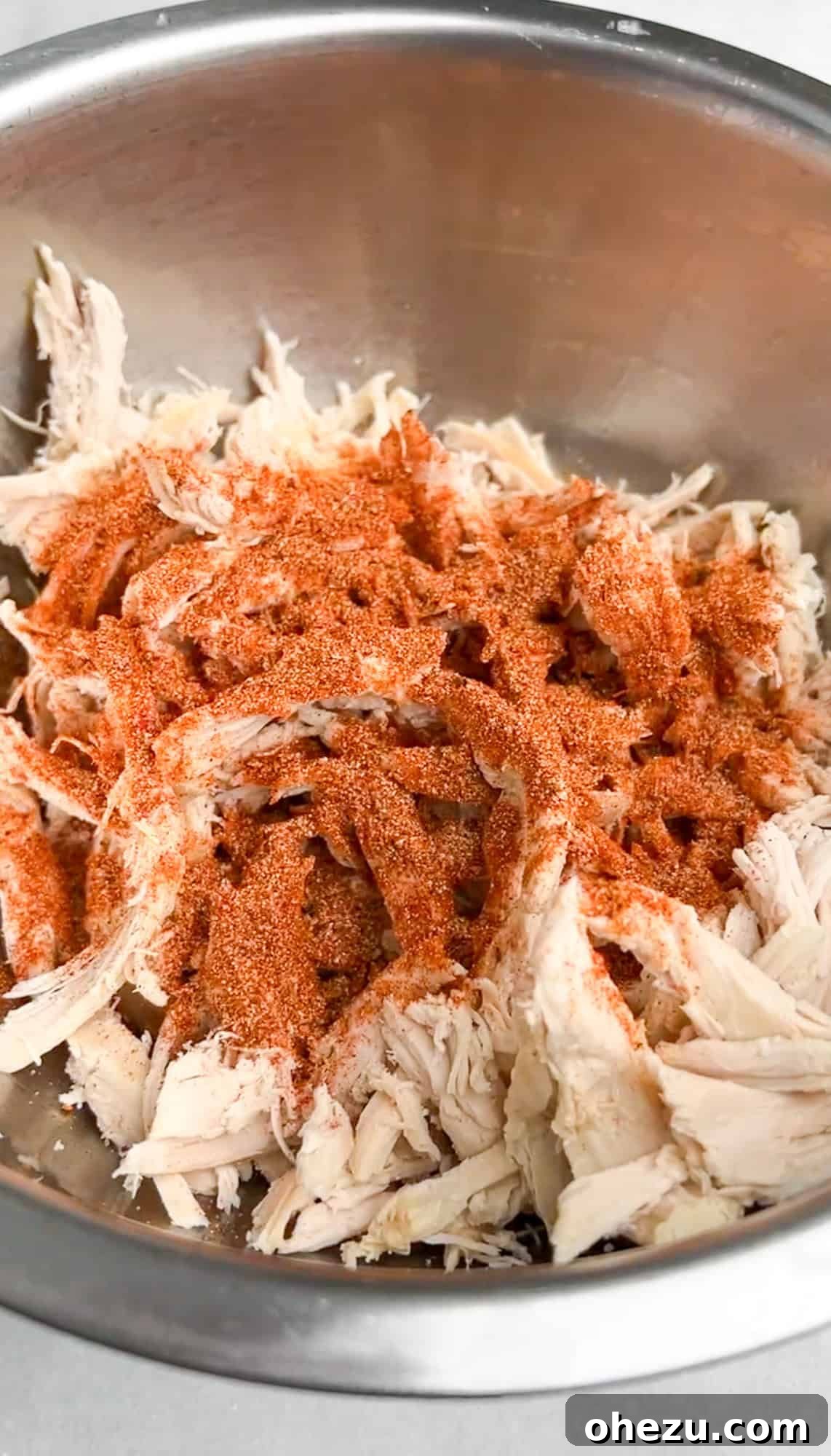 chicken in a bowl with seasonings