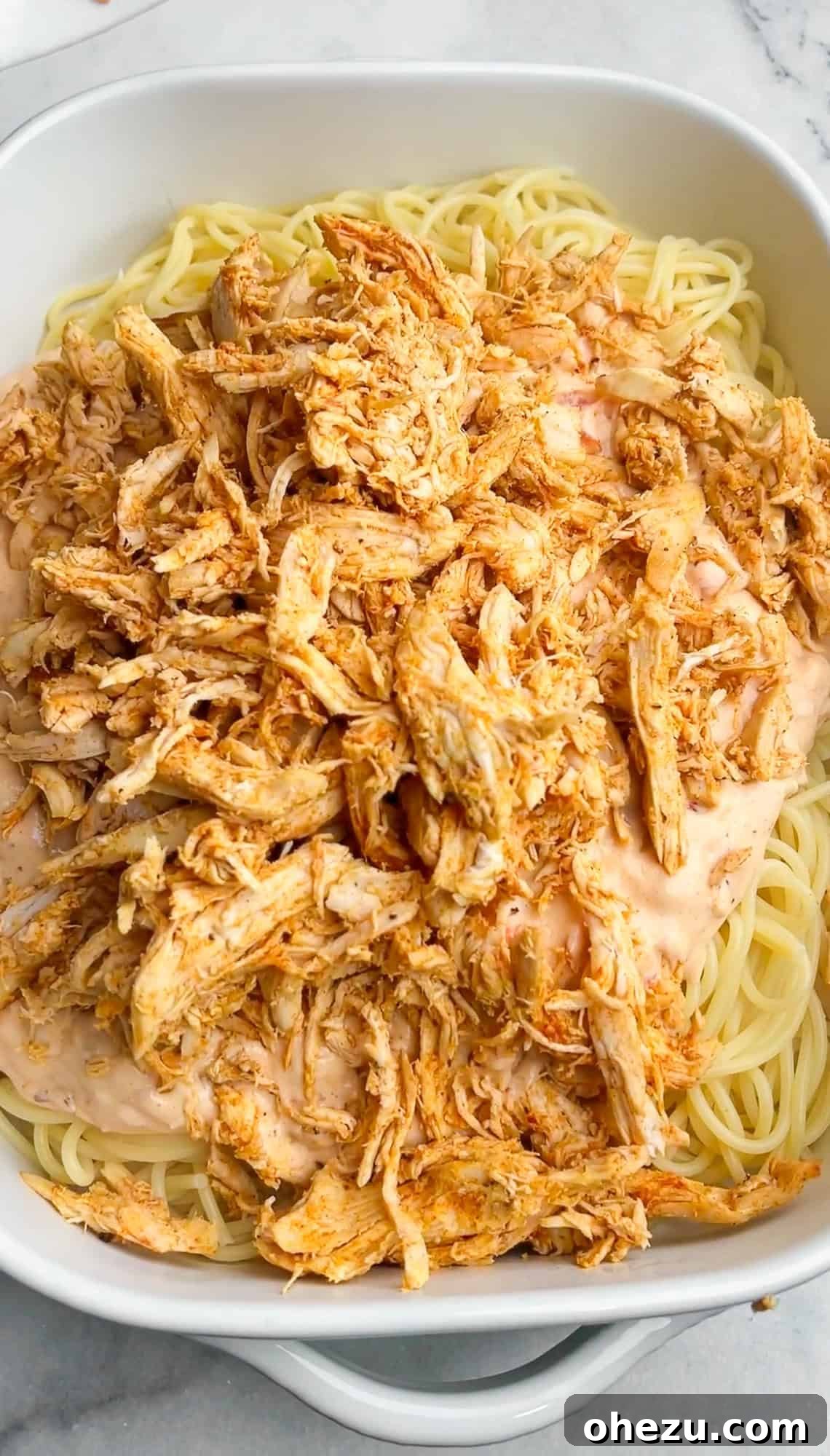 chicken added to spaghetti and cream sauce