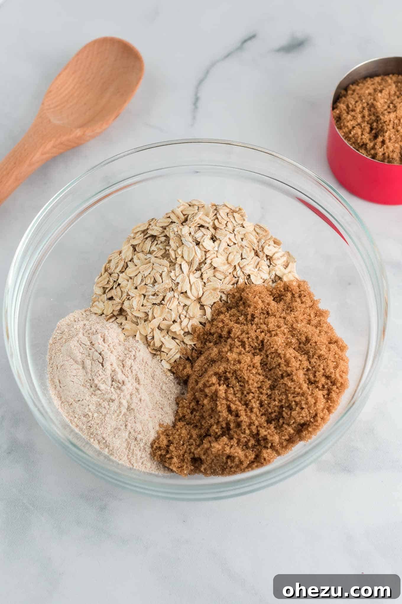 Dry ingredients for crisp topping: flour, oats, and brown sugar in a clear mixing bowl