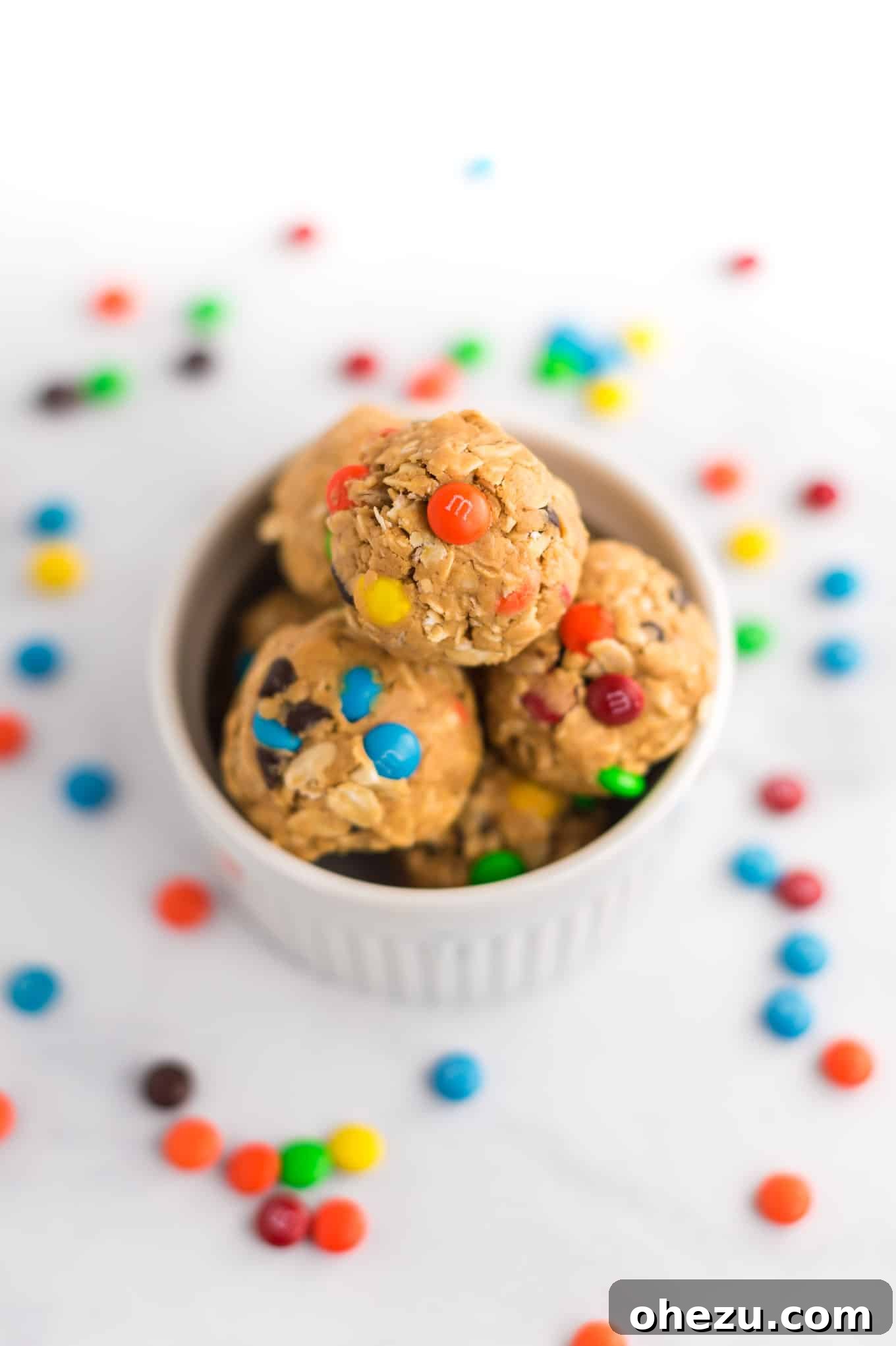 Ultimate Monster Cookie Fuel Bites 9 Finished monster cookie energy balls, perfectly stacked in a small white ramekin, ready to be enjoyed.