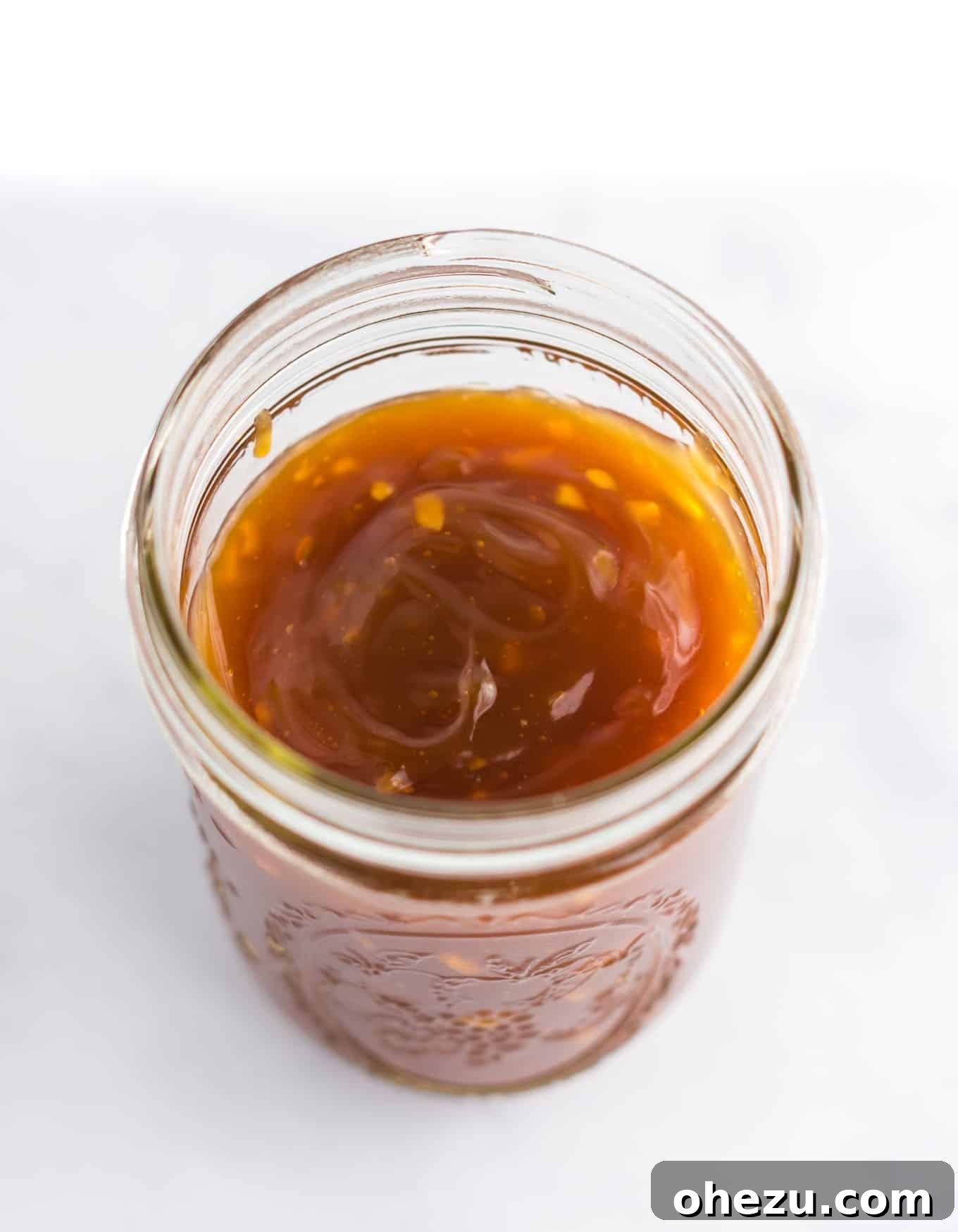 Zesty Orange Glaze 8 Close-up texture of the rich, thick, and glossy orange sauce, showing its smooth consistency.
