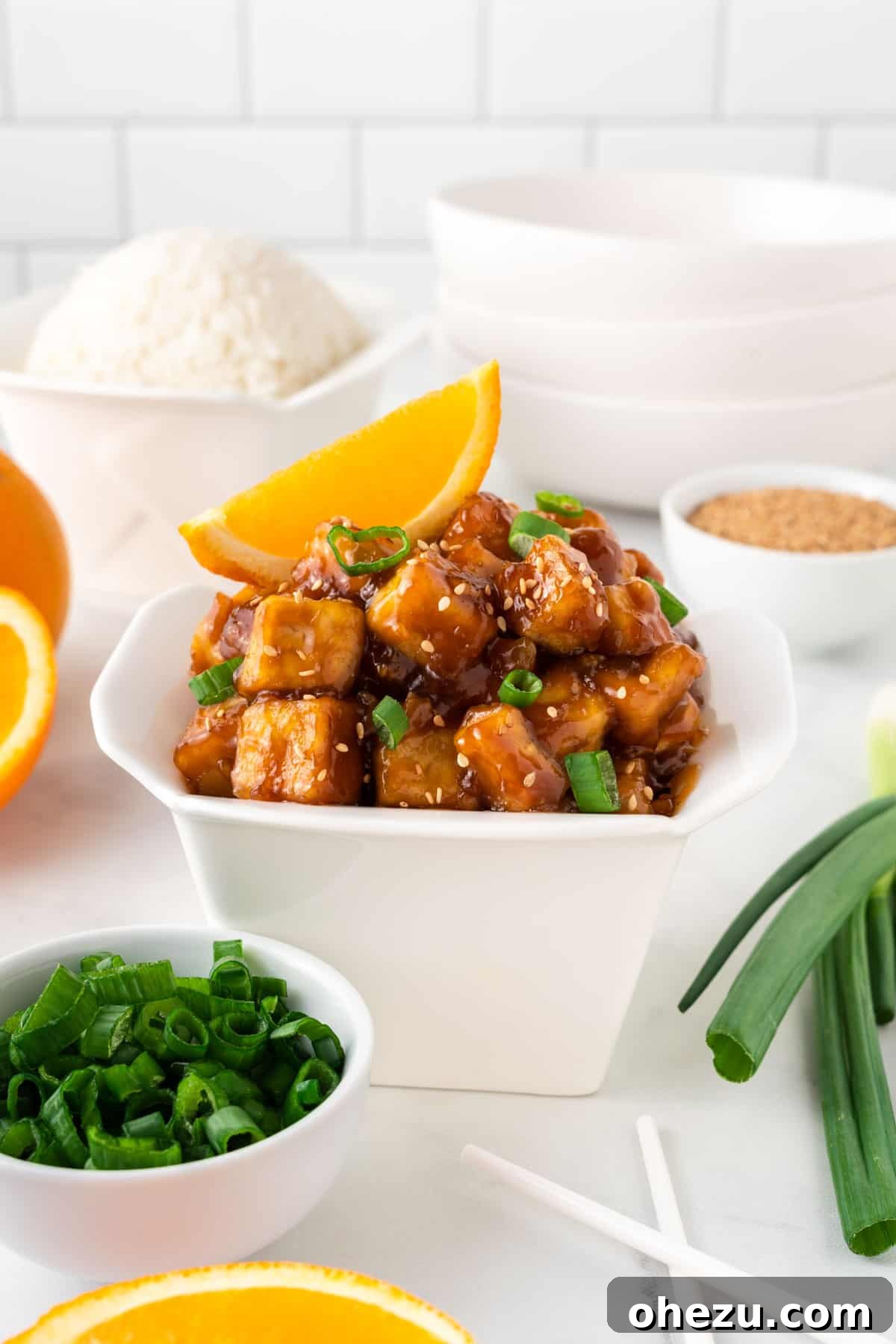 Crispy orange tofu packed neatly in a traditional Chinese takeout container, ready for serving or enjoyment.