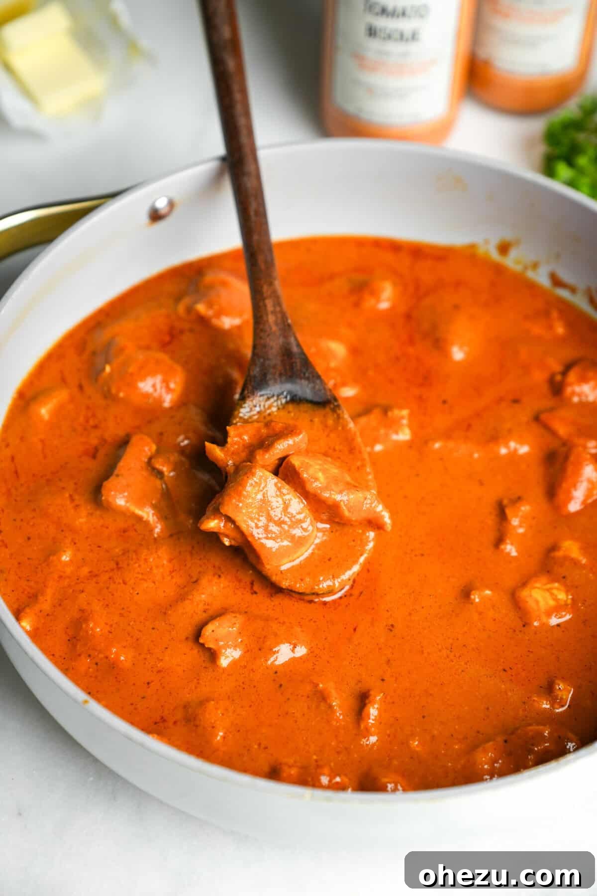 Effortless Butter Chicken 14 The finished, bubbling butter chicken in a skillet, garnished and ready to be served.