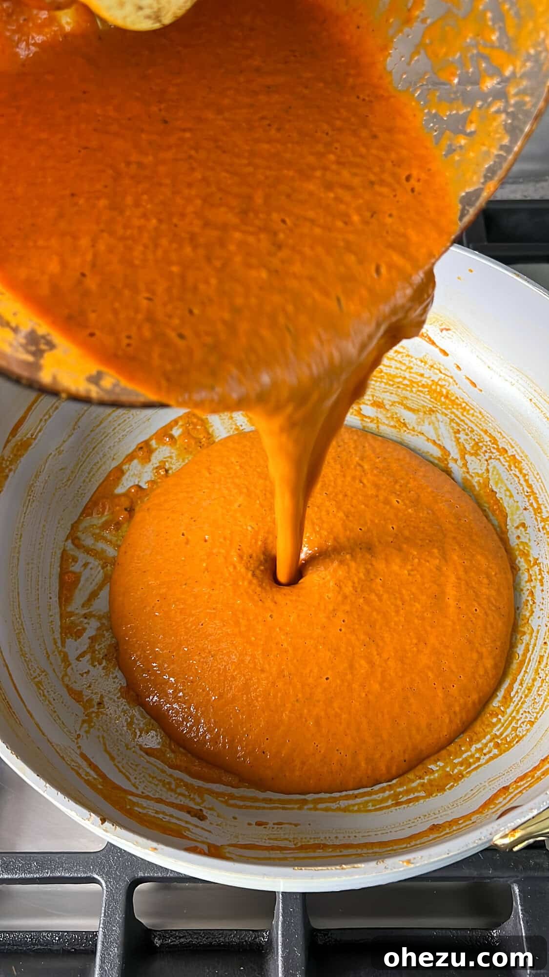 Effortless Butter Chicken 10 The velvety smooth butter chicken sauce being poured back into the pan after blending.