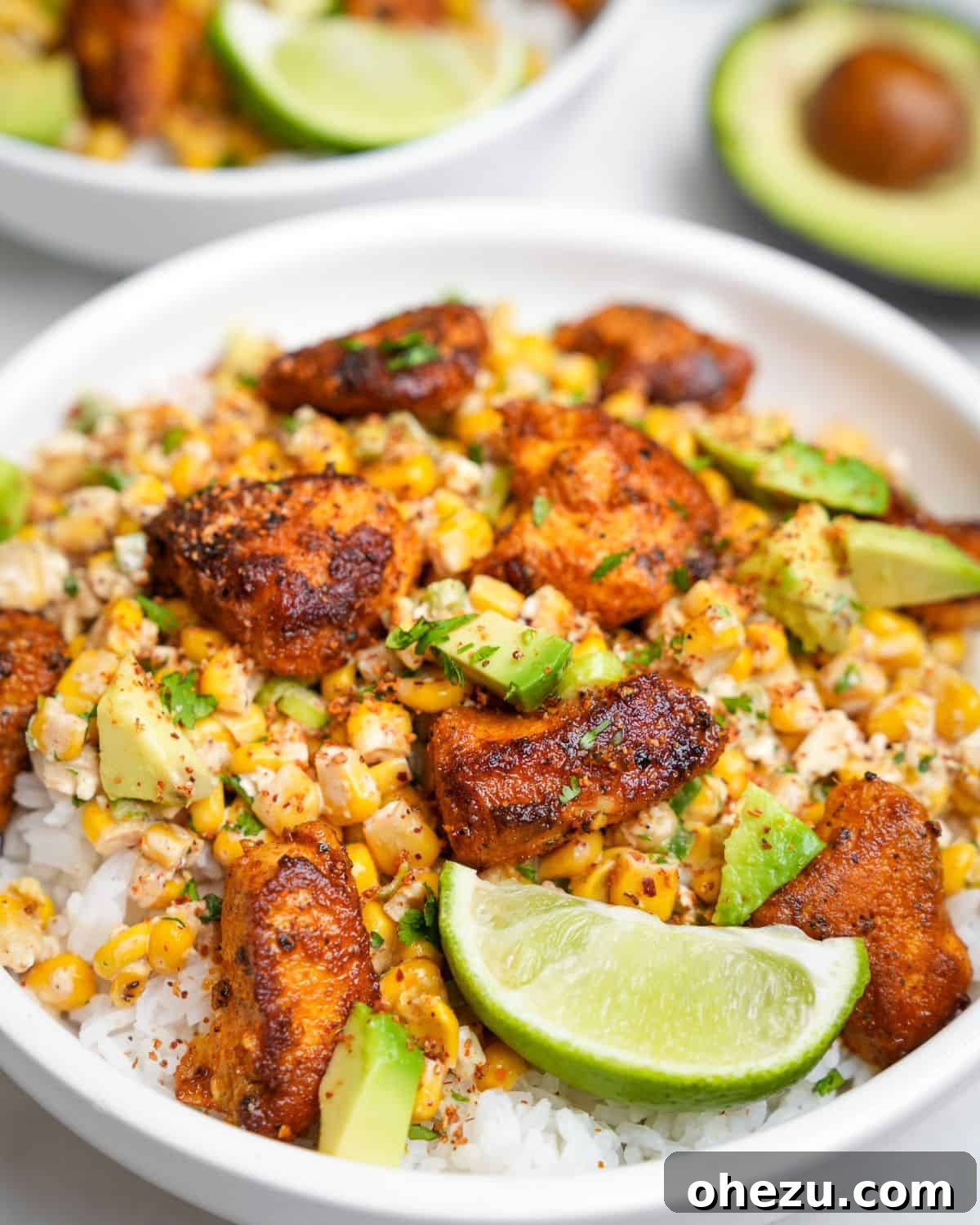 Zesty Street Corn Chicken Bowls 3 Meal prep containers filled with Street Corn Chicken Bowls, ready for the week.