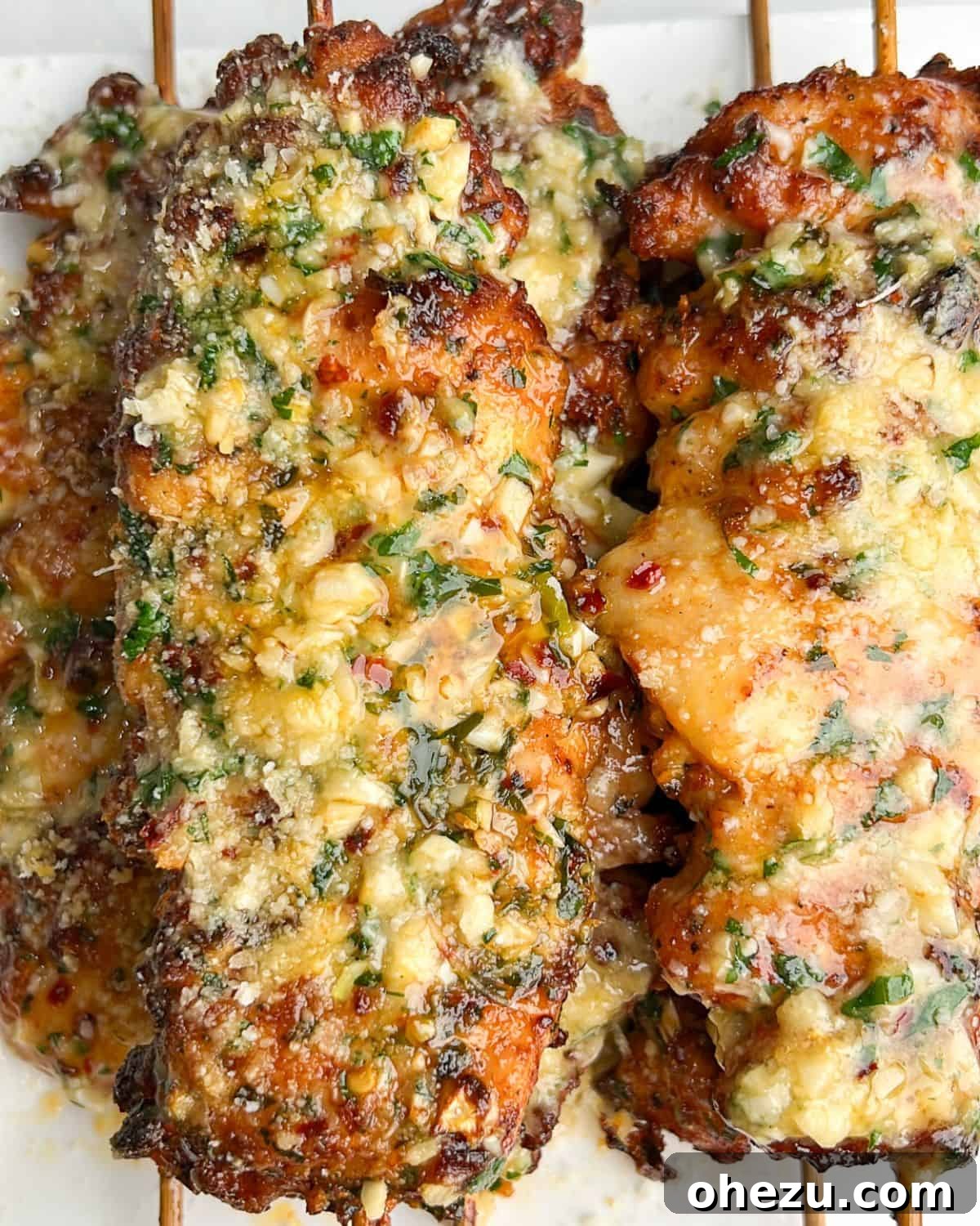 Over 20 Must-Try Recipes for Your Memorial Day Cookout 7 Delicious Garlic Parmesan Chicken Skewers, basted in butter sauce.