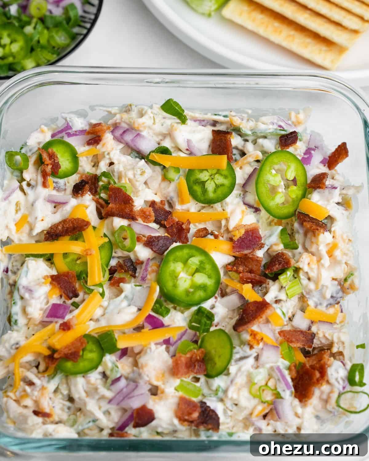 Large bowl of creamy Jalapeno Popper Chicken Salad, ready to be served, highlighting the vibrant colors of its ingredients.