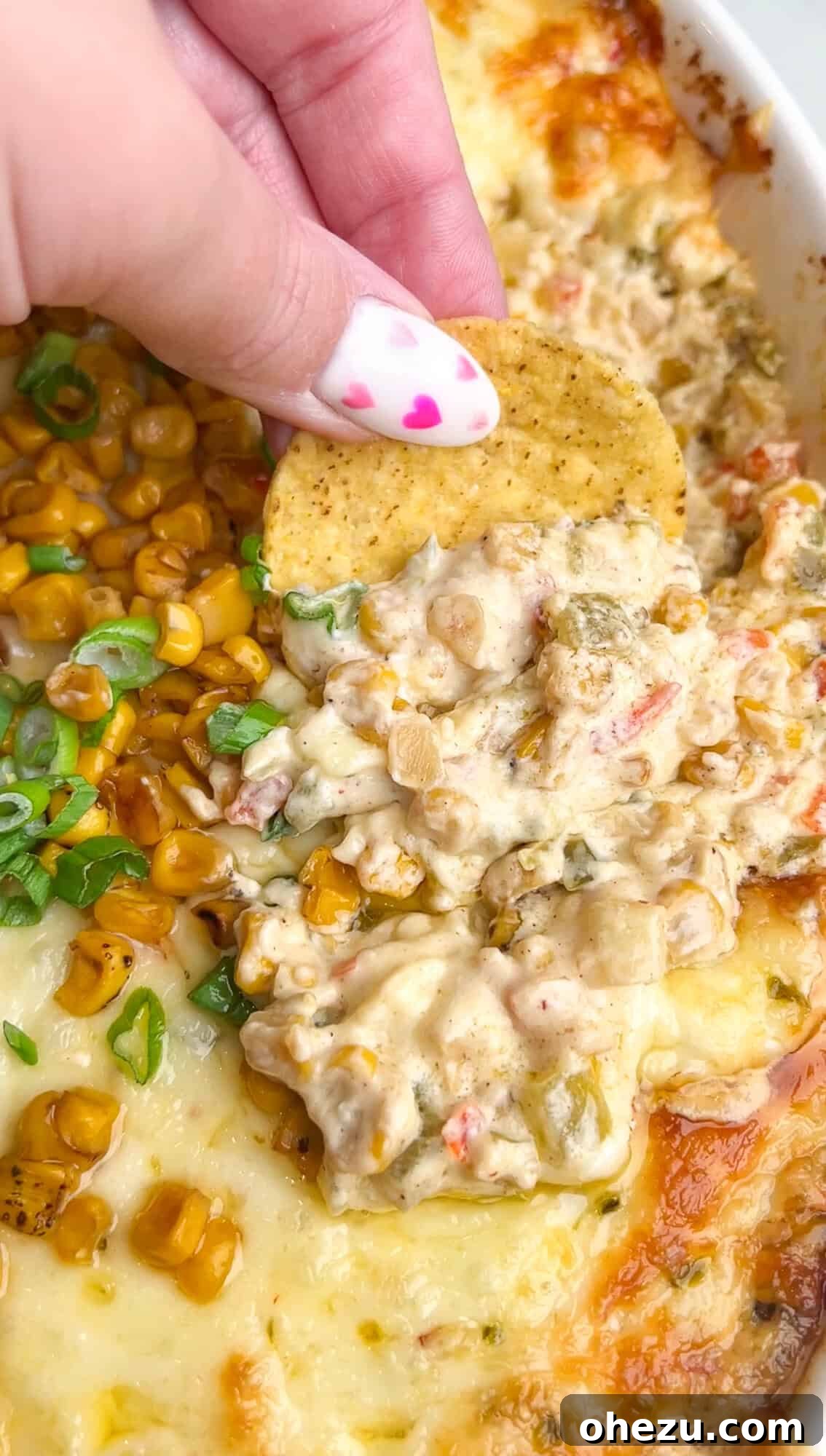 Golden brown baked corn dip in a rustic casserole dish, ready to be served.