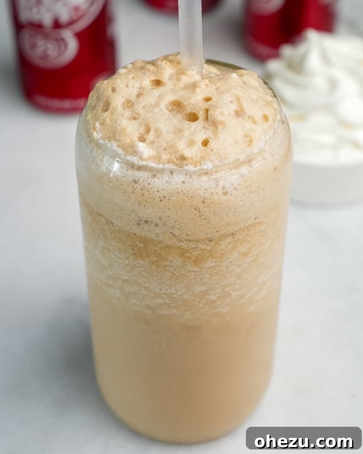 Close-up of the frothy, creamy texture of a frozen Dr. Pepper drink in a glass.