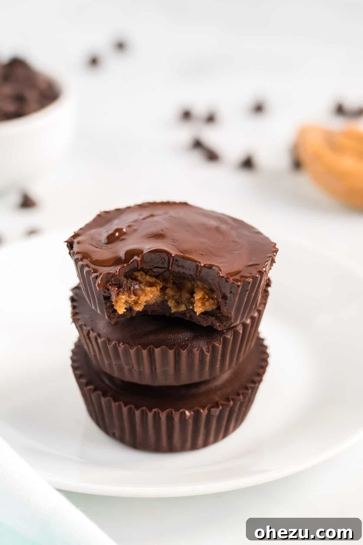 Decadent Vegan Peanut Butter Cups 11 stacked peanut butter cups with a bite taken out