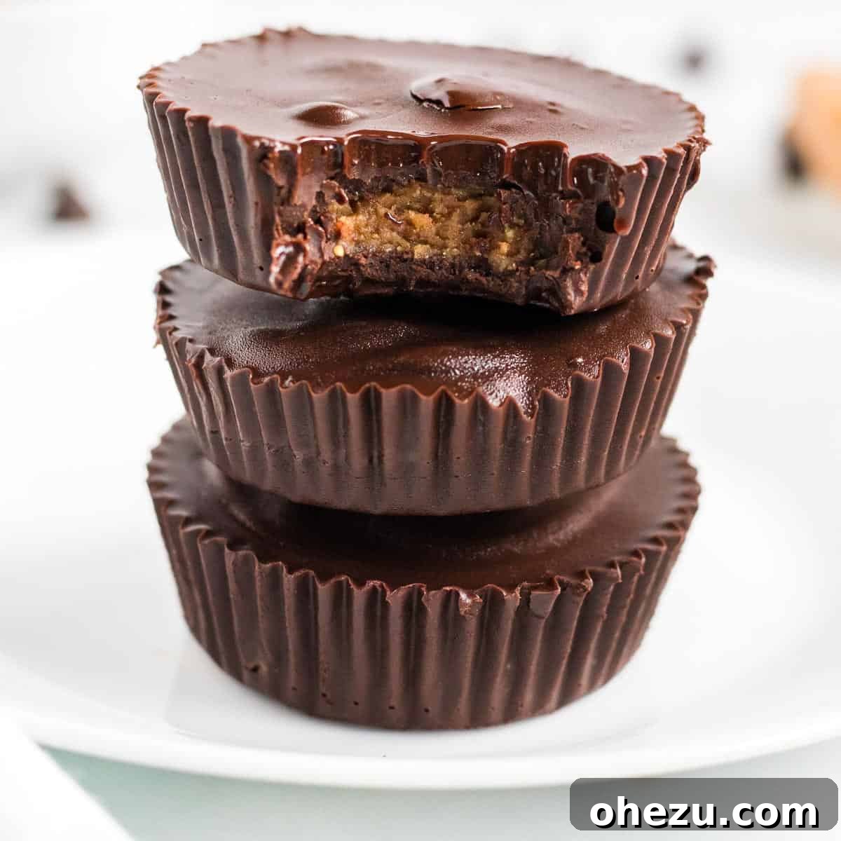 Decadent Vegan Peanut Butter Cups 9 stacked peanut butter cups with a bite taken out