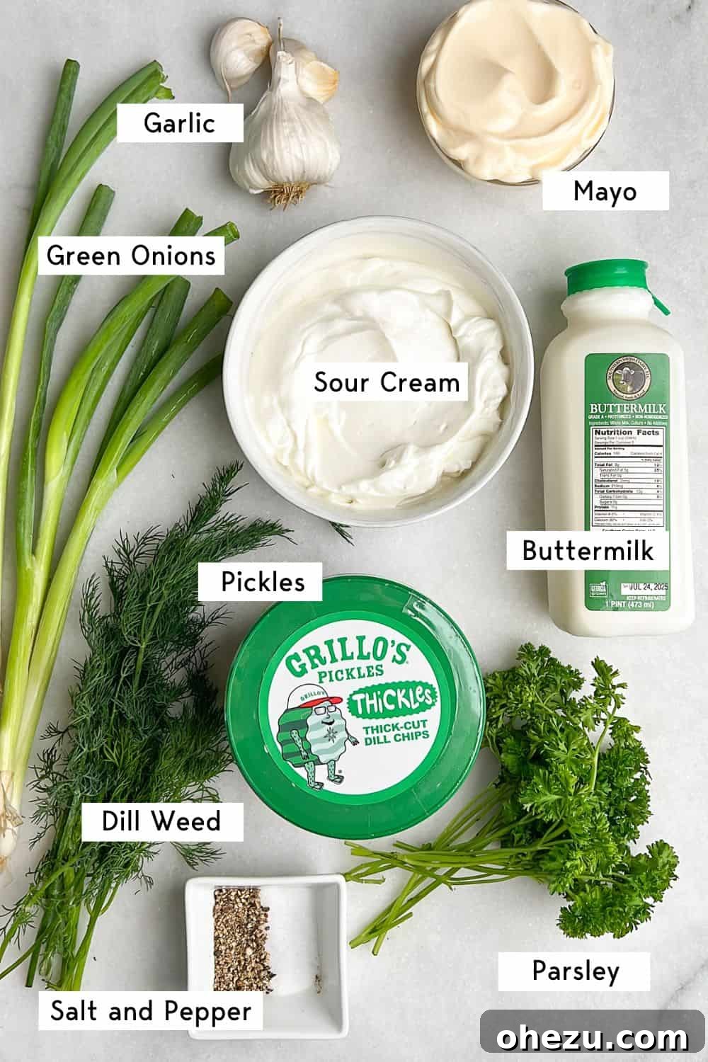 Dillicious Dip Sensation 4 An array of fresh ingredients laid out for making dill pickle dip, including pickles, herbs, and dairy.