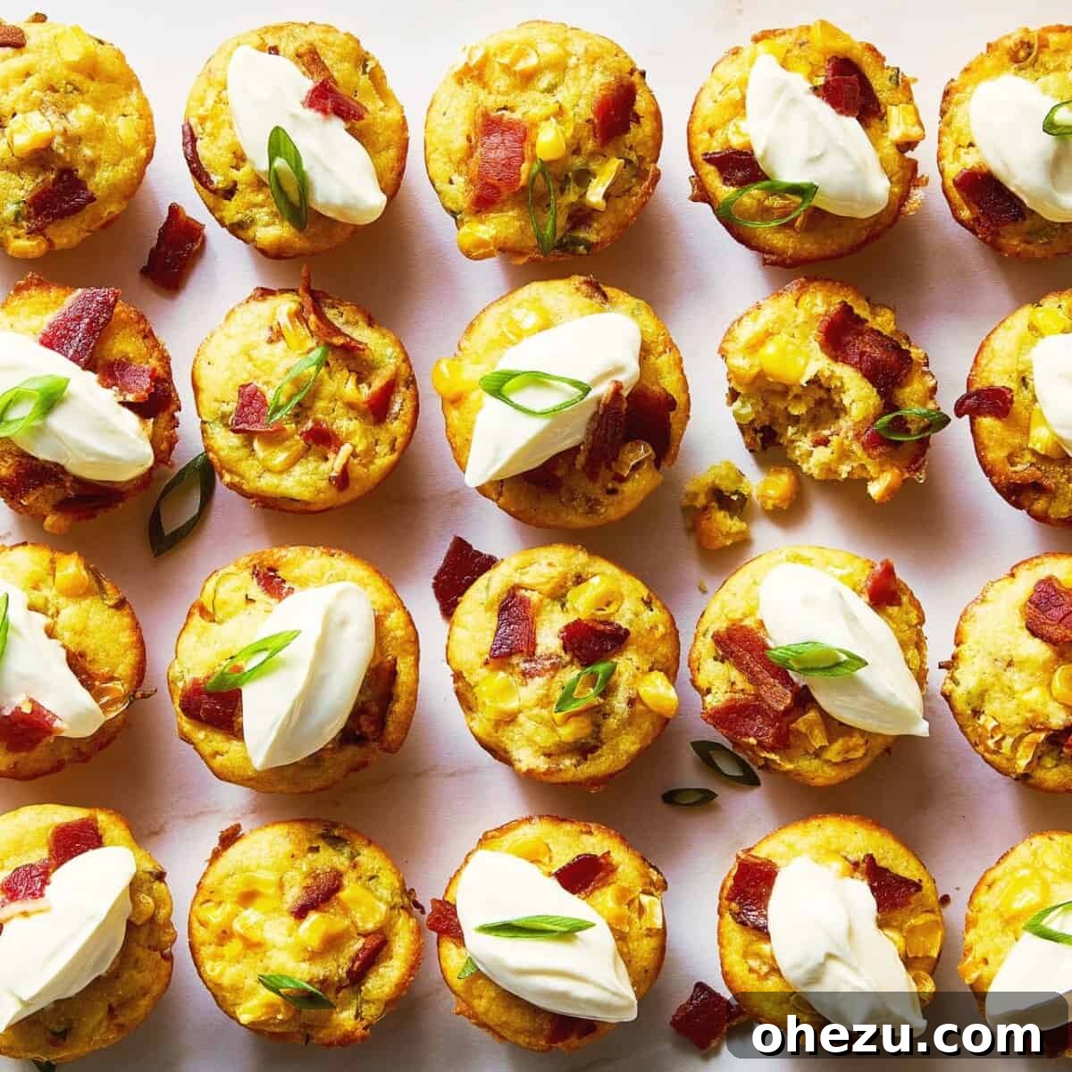 Mini loaded cheesy corn bites garnished with chives and bacon bits.