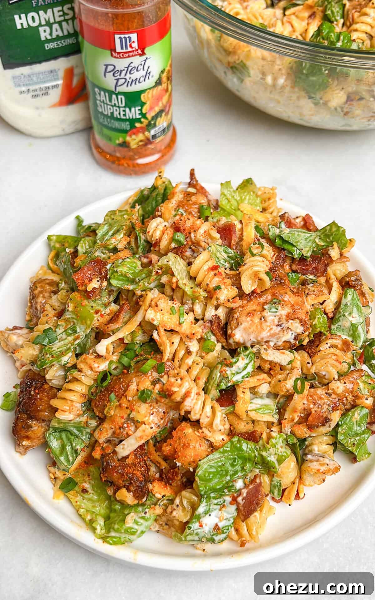 A large bowl of Chicken Bacon Ranch Pasta Salad with a creamy dressing.
