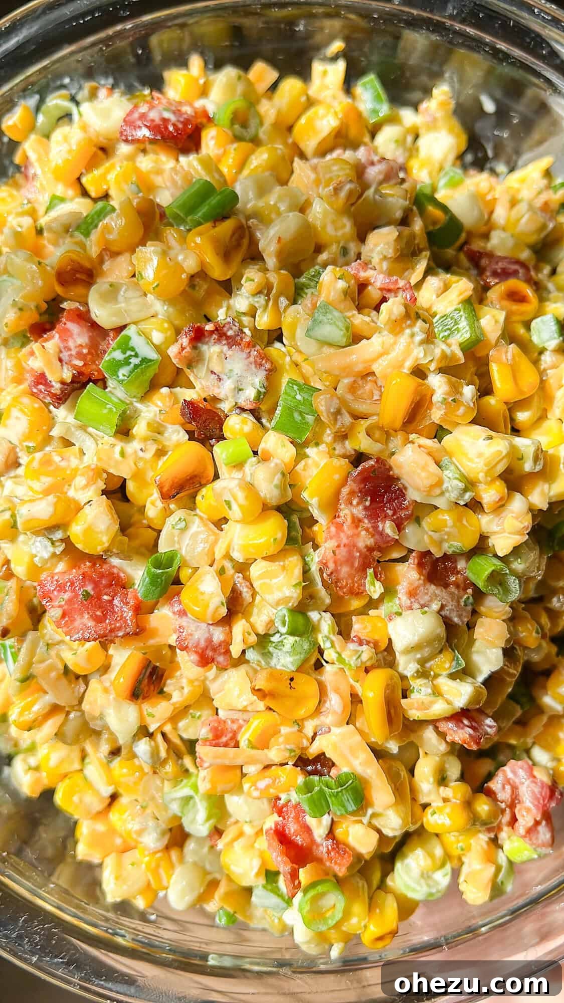 A vibrant bowl of Crack Corn Salad, garnished with fresh herbs.