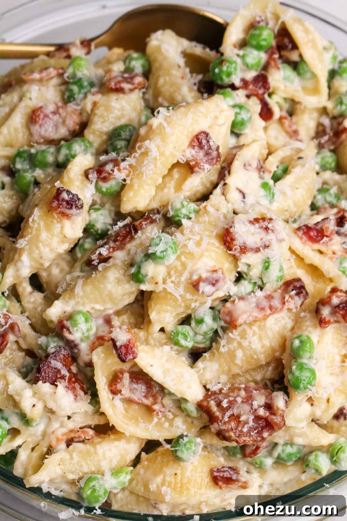 A serving bowl of Creamy Pea and Bacon Pasta Salad, a delightful and easy side dish.