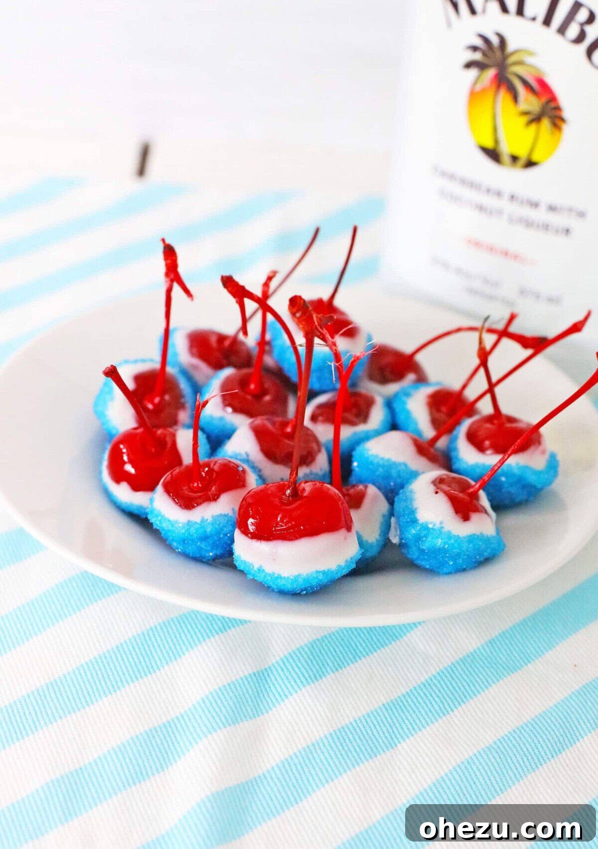 A bowl of vibrant Boozy Cherry Bombs, perfect for an adult 4th of July treat.