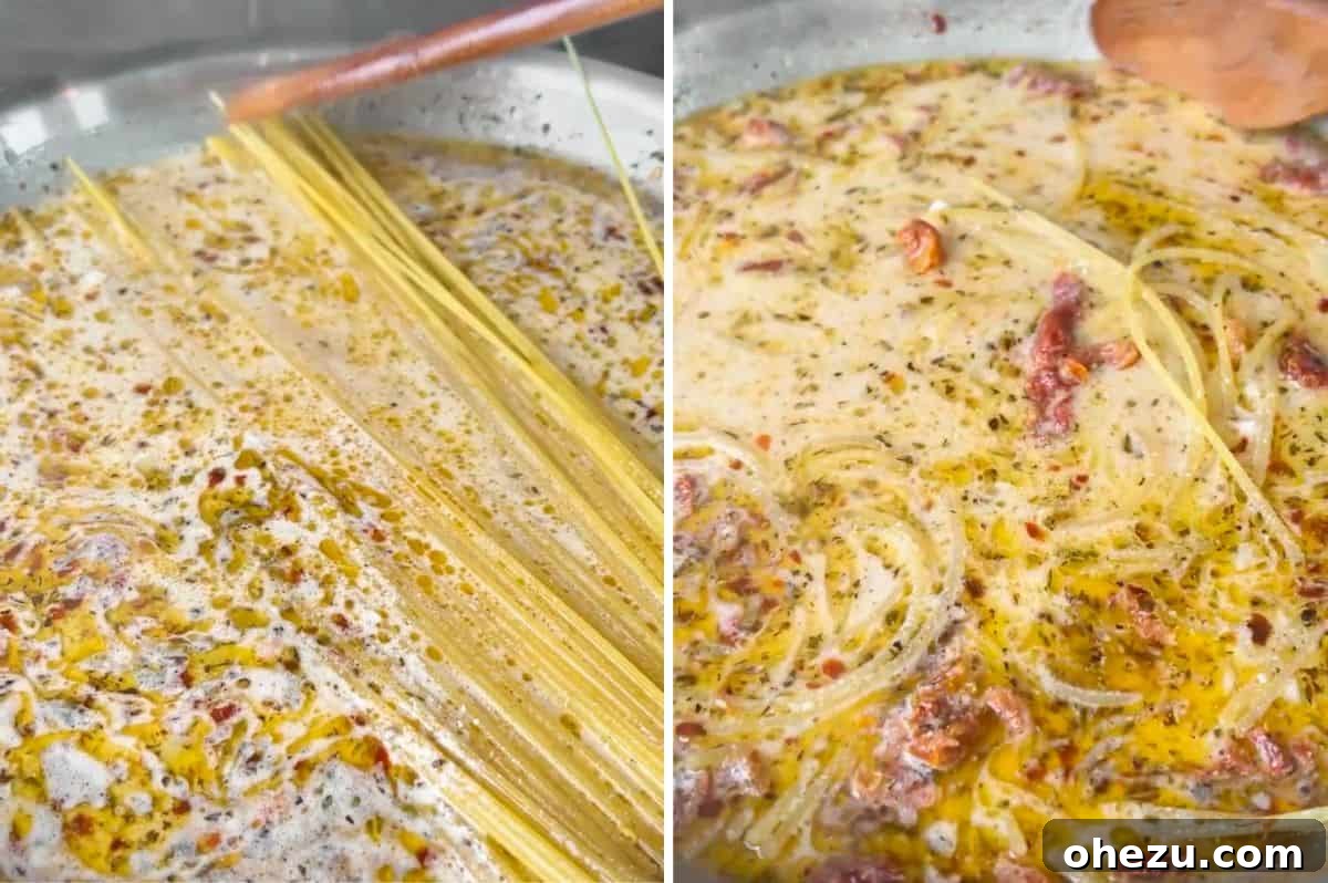 Tuscan Skillet Cream Pasta 6 Step-by-step image: Adding dry spaghetti into the one-pan creamy Tuscan pasta sauce, where it will cook.