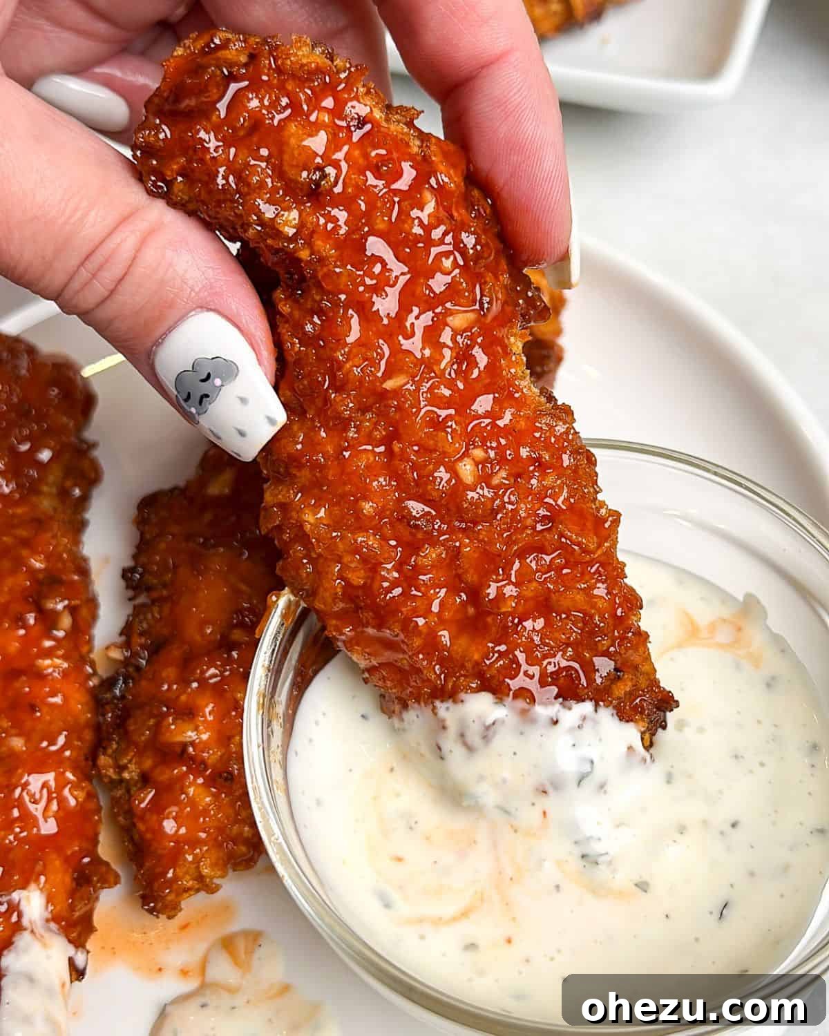 Crispy Air-Fried Honey Buffalo Chicken Strips 2 air fried chicken tenders coated in honey buffalo sauce