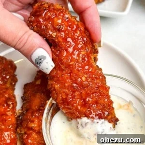 Crispy Air-Fried Honey Buffalo Chicken Strips 8 honey buffalo chicken tenders on a plate