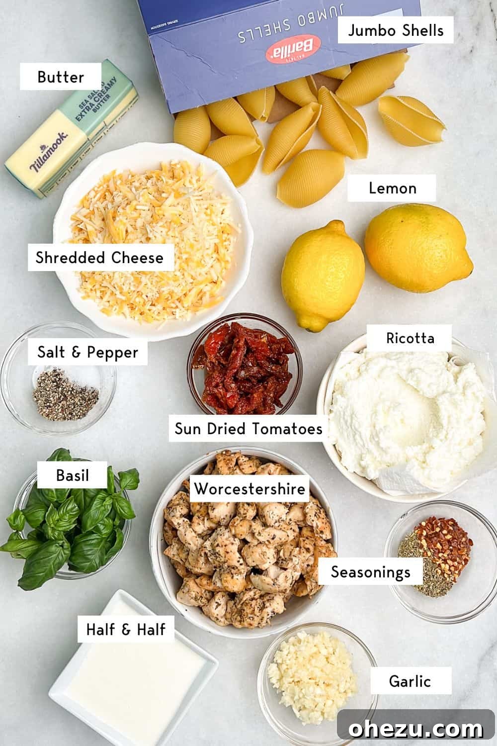 The vibrant ingredients for Marry Me Chicken Stuffed Shells, including chicken, sun-dried tomatoes, ricotta, and fresh lemon, promising a rich, creamy sauce. Essential ingredients laid out for making Marry Me Chicken Stuffed Shells, ready for preparation.