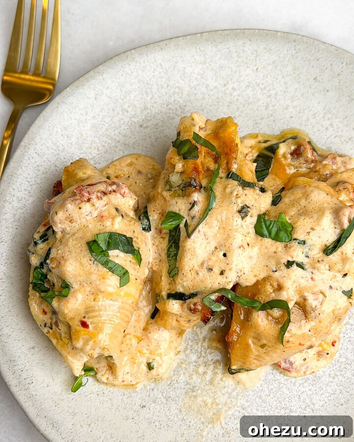 The exquisite Marry Me Chicken Stuffed Shells, baked to a beautiful golden perfection. A tantalizing view of baked Marry Me Chicken Stuffed Shells, ready to be enjoyed with a perfect golden crust.